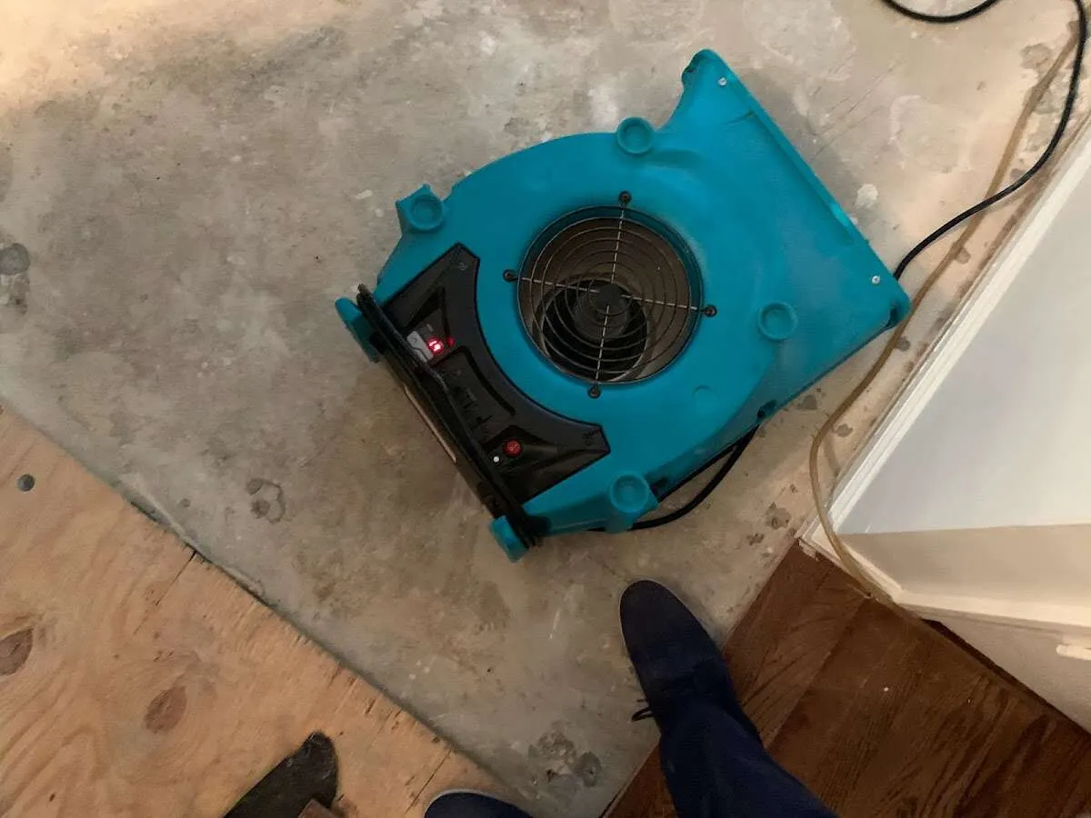Air mover drying subfloor during Commercial Water Damage Restoration in Gaffney